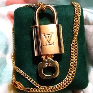 Louis Vuitton lock  🔐 w/  key 🔑  on a gold tone chain
